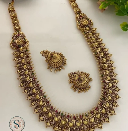 This Antique Temple Haram is crafted with detailed goddess motifs — a perfect pick for brides & festive occasions.