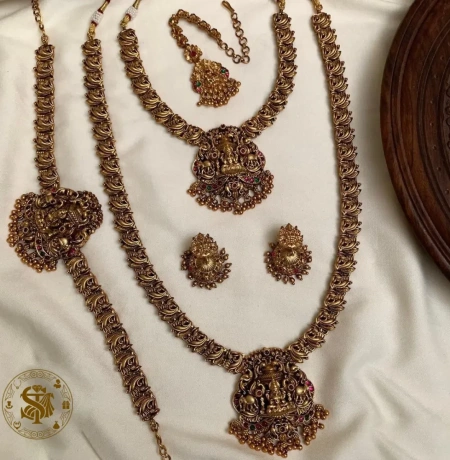 Antique Gold Plated Lakshmi Temple Jewelry Combo Set with Choker, Long Haram, Maang Tikka, Vanki, and Jhumkas